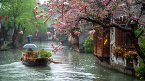 In the water town of Jiangnan, the ancient crabapple trees on the riverbank are full of colorful flowers. The houses in Jiangnan style allow people to walk along the riverbank in raincoats to work or go home. The boatman drove his small wooden boat along the flowing water. It's spring now, and the weather is rainy. Green plants and flowers have just emerged. You can also see traffic lights next to these houses. This photo was taken up close and has a high resolution, which is the style of traditional Ch