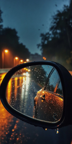 夜晚，下雨，角度拍汽车镜子，行驶在道路上