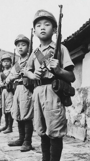 In the summer of 20th century, China's Nationalist forces were at war with Japanese barbarians in far away tropical island. They captured many young Chinese soldiers and fratoph adding to their army . The photo was taken by black-and-white cameras from Japan, they can see Asian boys aged between ten years old and twelve years old wearing military uniforms carrying guns on them as navy-style props, while also being held up against a wall or set for use as martial arts action scenes. It is very detailed a