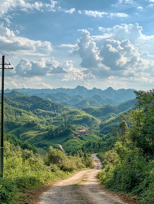 在远处,有一个电线杆和一些山丘在前面。在近处,你可以看到道路两边的绿树。天空中有白云飘过,构成了一幅美丽的景象。这张照片是用手机的人像模式拍摄的。它展示了中国贵州省的风光。一座小山峰位于中心,周围环绕着其他较小的山峰。附近还有另一个看似房屋或建筑的结构。